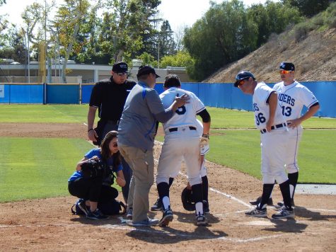 Moorpark's Garrett Kueber is helped to his feet after being struck by a pitch in the game against Oxnard College on Saturday.