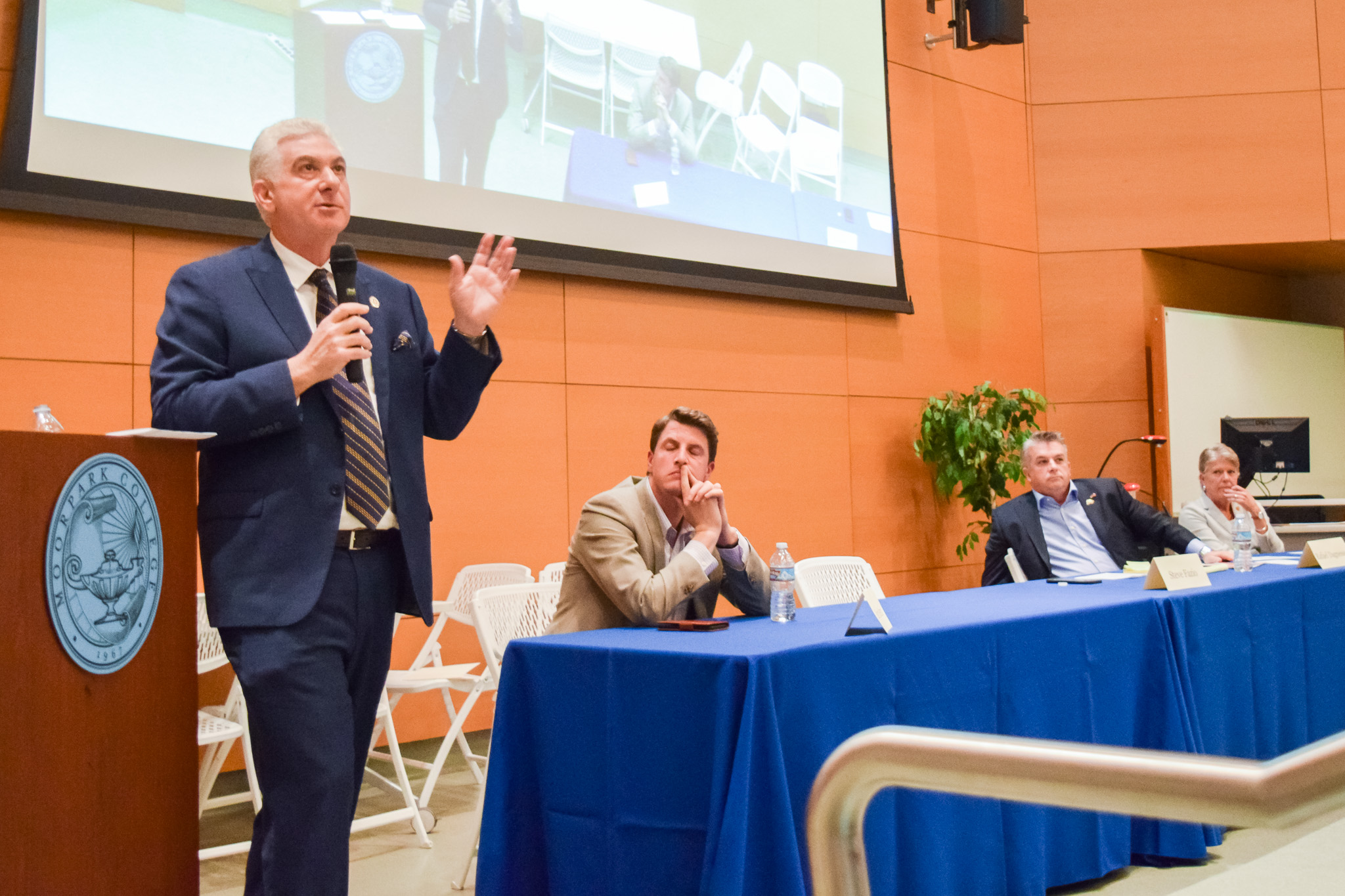Steve Fazio, running for California State Senate, District 27, speaks as his opponent, Henry Stern listens, along with House Candidates Rafael Dagnesses and Julia Brownley during Moorpark College's Candidate Forum.