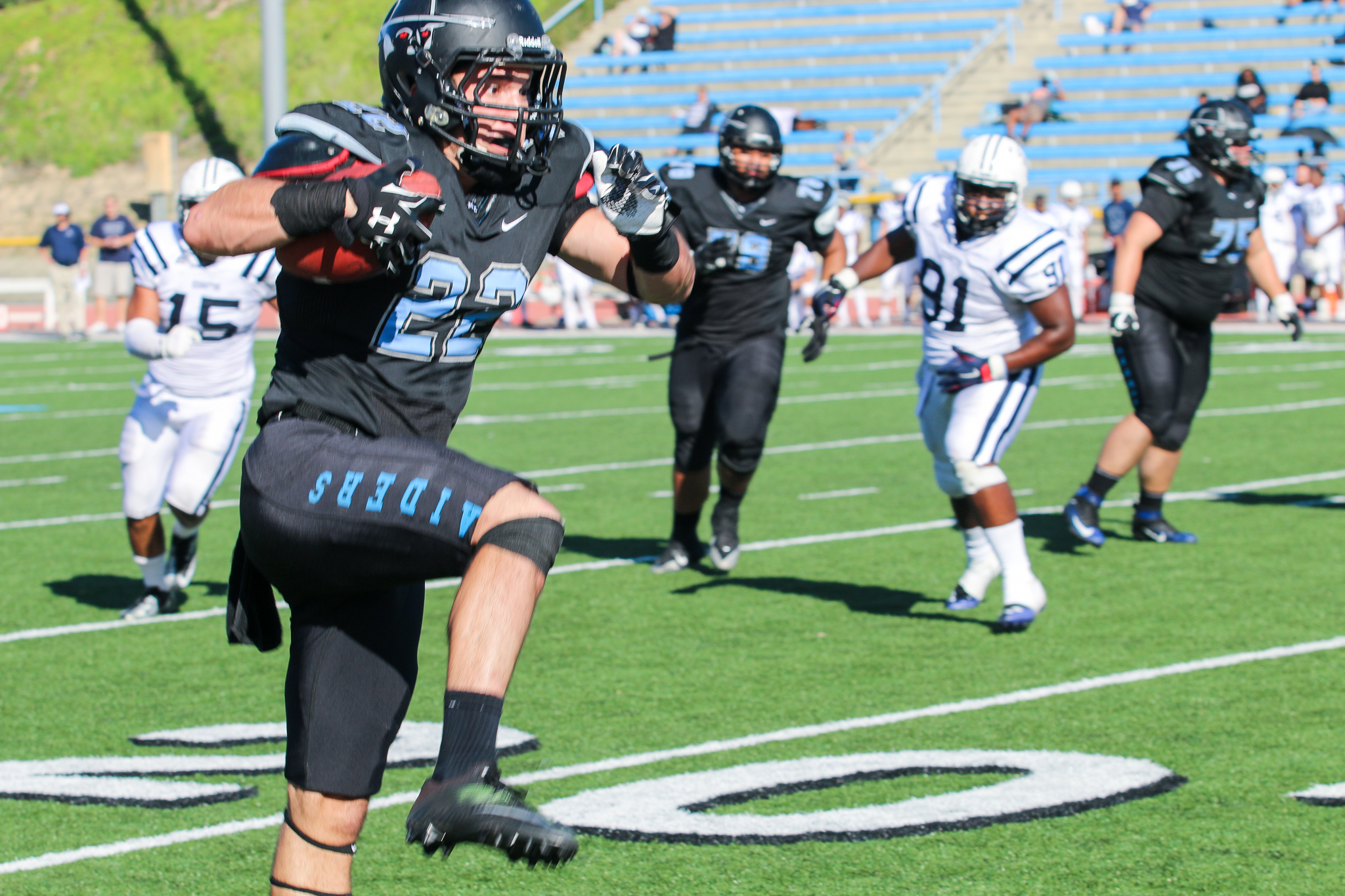 Moorpark wide receiver Corbin Covey prepares to hurdle over a Cerritos College defender en route to a 22-yard touchdown during Saturday's win. 